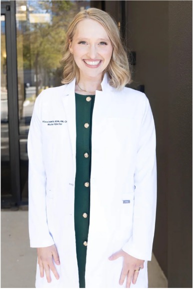 Kiara DeWitt in a white clinical coat
